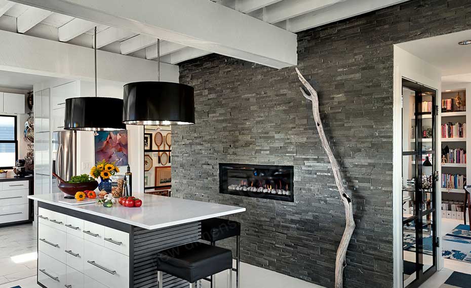 Dimensional Stacked Stone Fireplace with gas insert and Feature Wall in a kitchen in Austin with beautiful vaulted celings